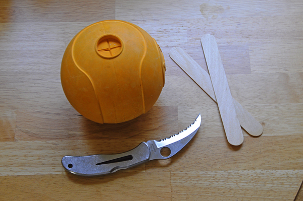 rubber ball, popsicle sticks, and knife
